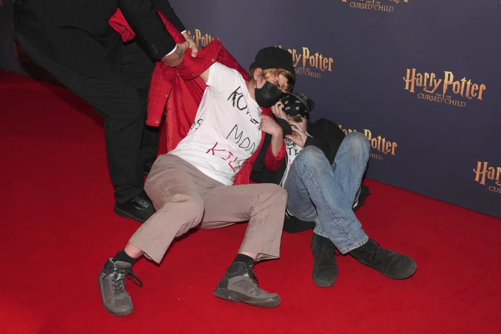 Trans-rights protestors are removed from the red carpet at a gala performance of Harry Potter and the Cursed Child.