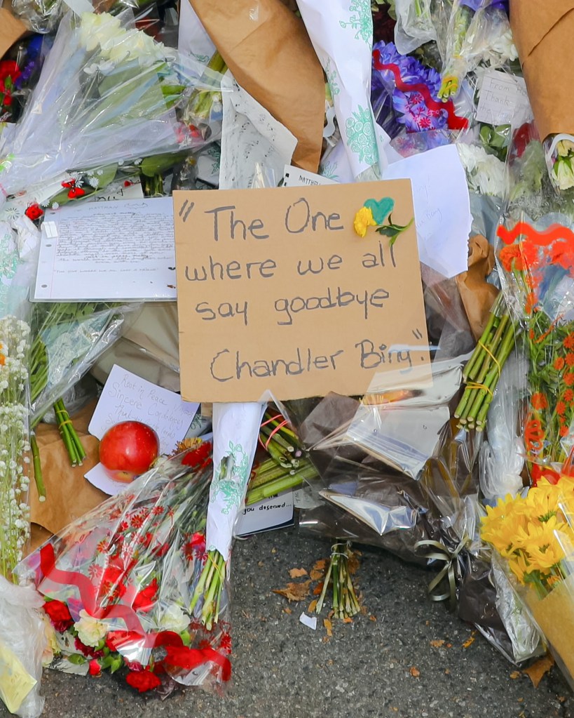 Tributes and flowers left for Matthew Perry at the Friends apartment building.