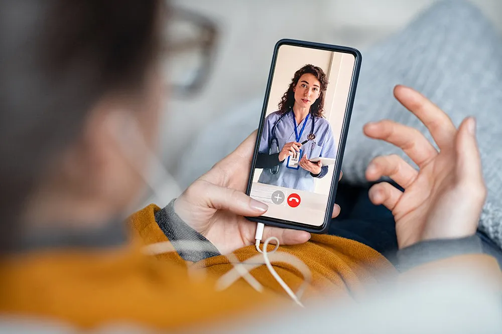 A person having a telehealth call over the phone.
