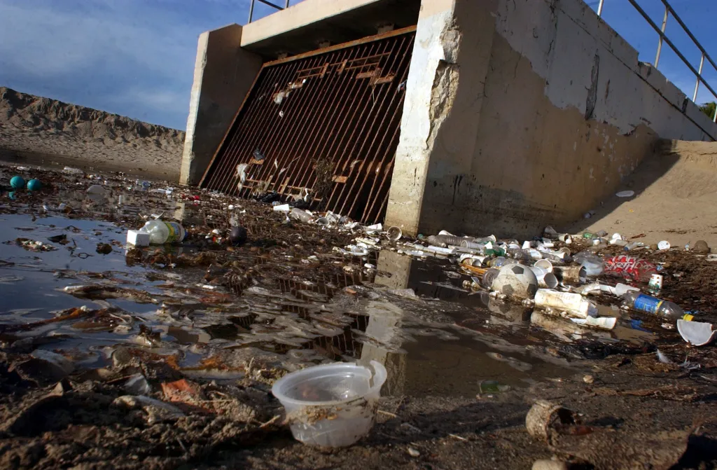 Trash collects at the mouth of a storm drain along Venice Beach.