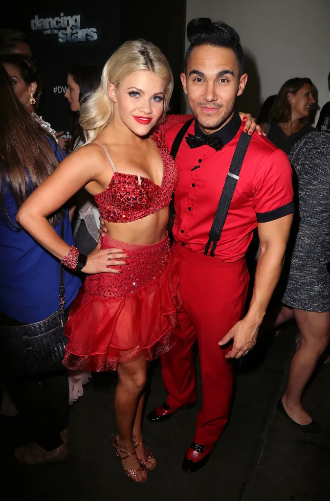 TV personality and dancer Witney Carson and actor Carlos PenaVega posing together.
