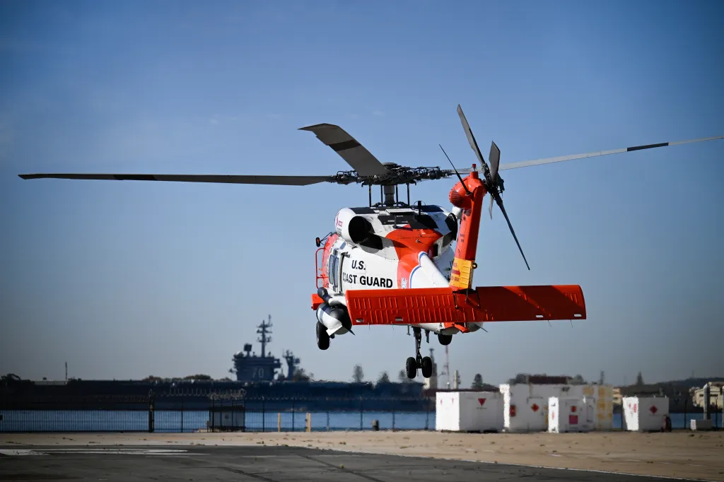 A U.S. Coast Guard helicopter lifting off at Coast Guard Station San Diego.