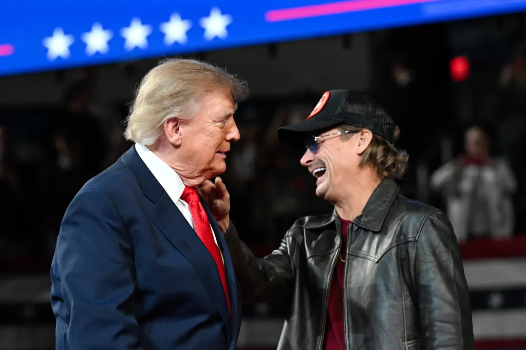 President Donald Trump greets musician Kid Rock at a rally.