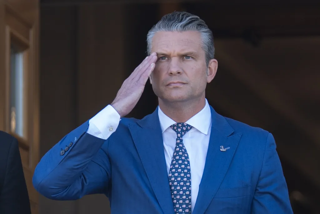 U.S. Secretary of Defense Pete Hegseth saluting during an honor cordon at the Pentagon.