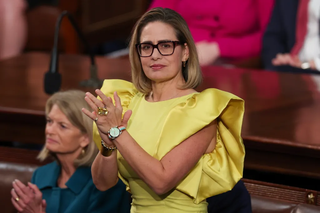 U.S. Sen. Kyrsten Sinema applauds during the State of the Union address.