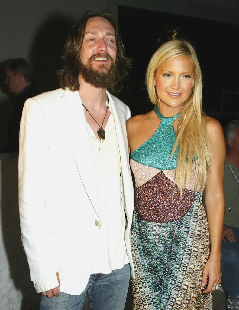 Kate Hudson and Chris Robinson standing together at an event.