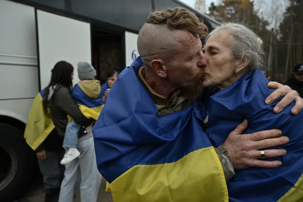 Ukrainian serviceman Dmytro kisses his wife Larysa upon her arrival in Ukraine after she was evacuated from Oleshky.