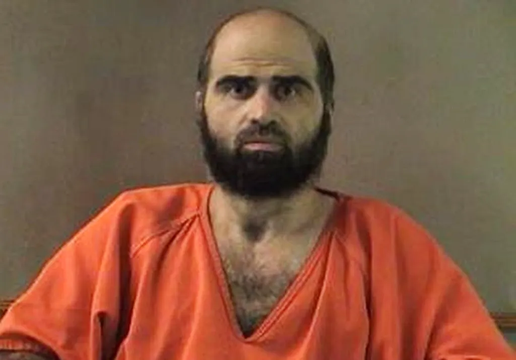 Portrait of former Army psychiatrist Maj. Nidal Hasan in an orange jumpsuit.