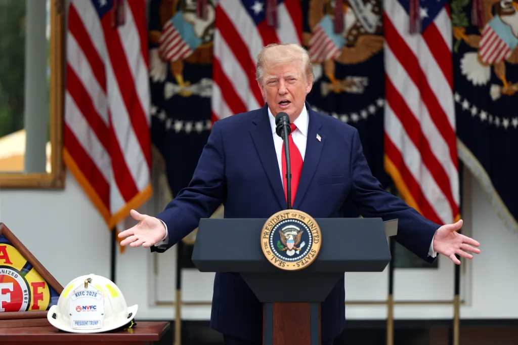 US President Donald J. Trump speaks behind a presidential lectern with American flags in the background.