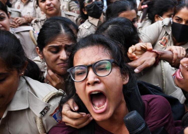 Crowds throng New Delhi and wave Indian flags amid escalating protests
