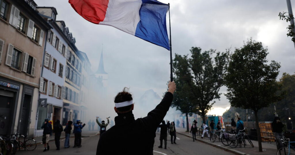 Police and protesters clash in Paris as an estimated 410,000 demonstrate across France
