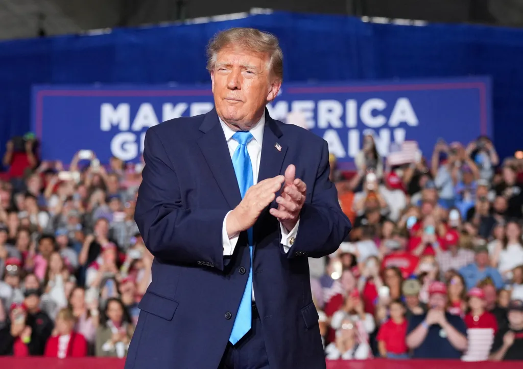 U.S. President Donald Trump claps during a rally in Grand Island, Nebraska.
