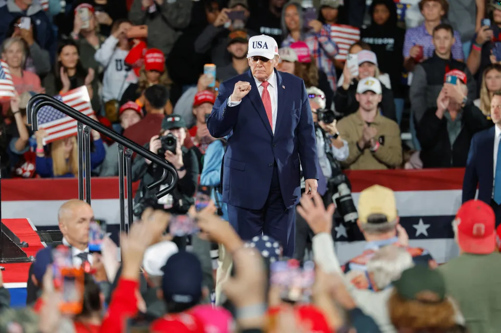 US President Donald Trump gestures towards supporters after leaving the stage during a campaign rally.