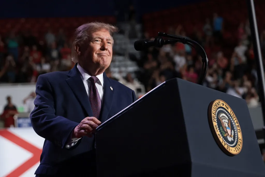 U.S. President Donald Trump speaks at a podium during a rally at the University of South Alabama in Mobile, Alabama.