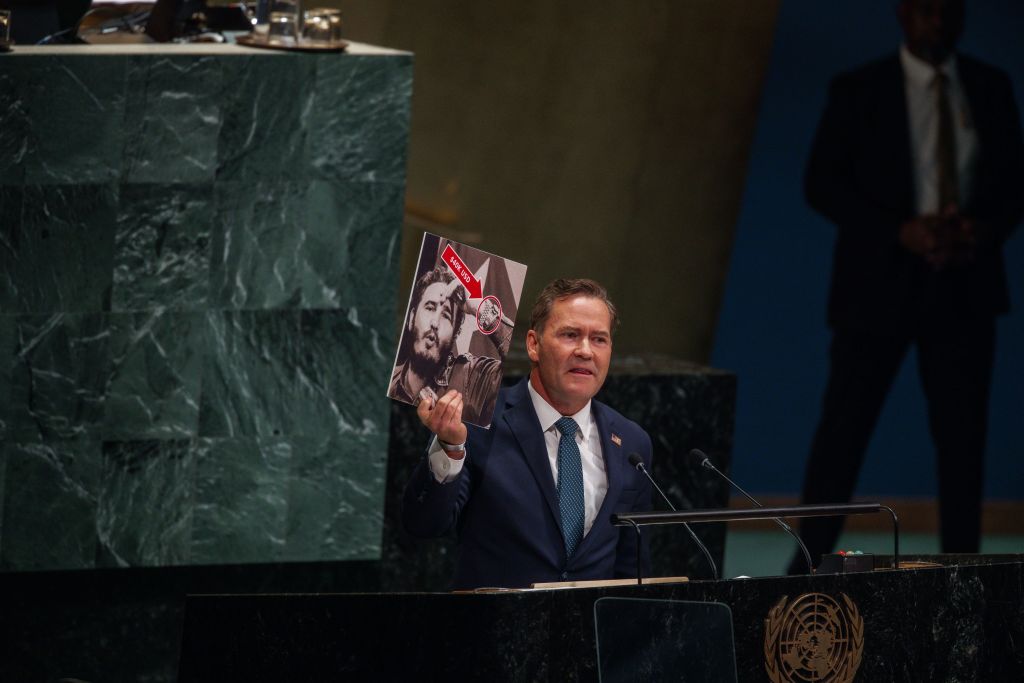 U.S. Representative to the United Nations Michael Waltz holds up a photograph of former Cuban leader Fidel Castro wearing a luxury watch while speaking at UN Headquarters.