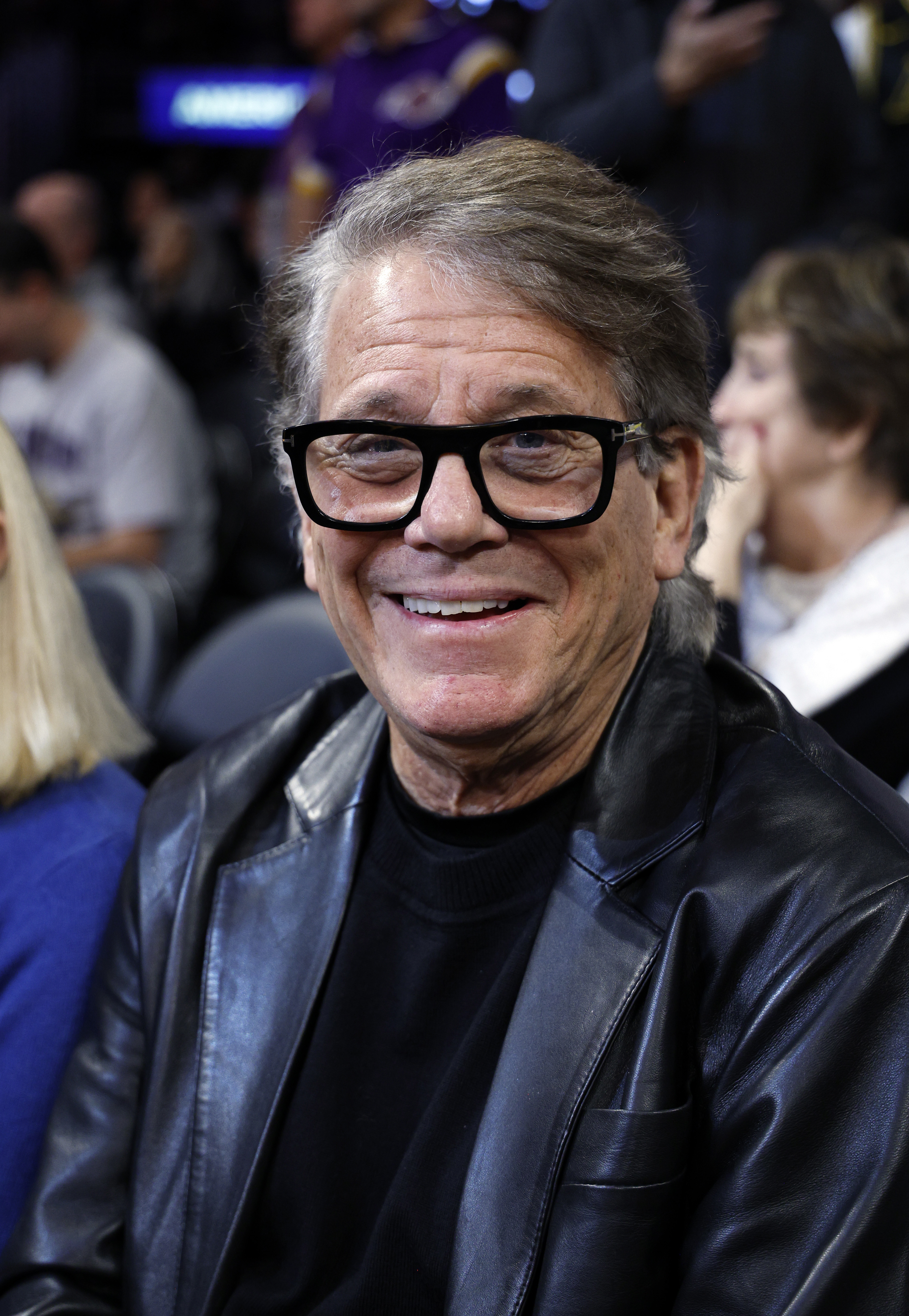 Anson Williams smiling at a basketball game.