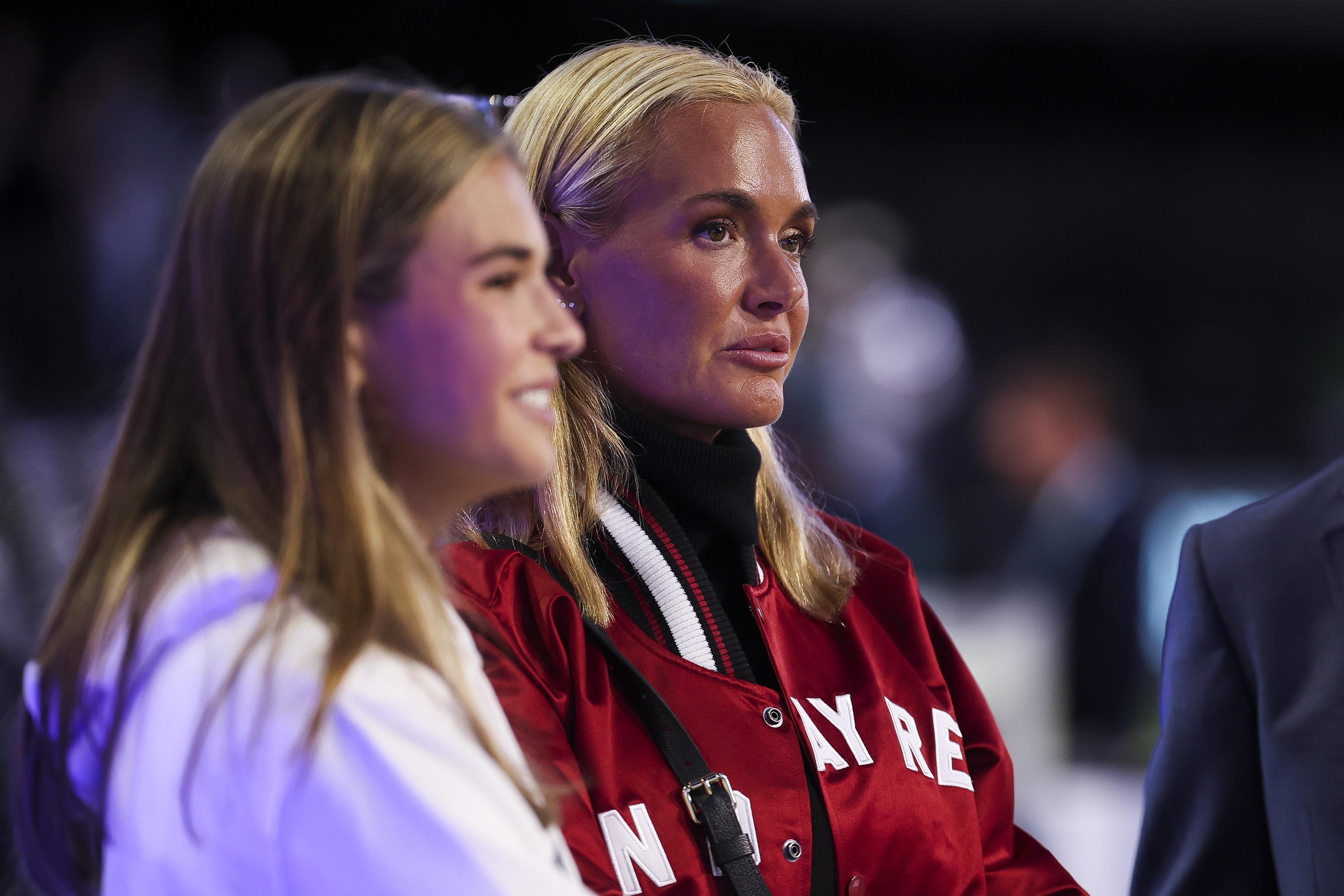 Vanessa Trump and her daughter Kai Trump look on during a golf match.