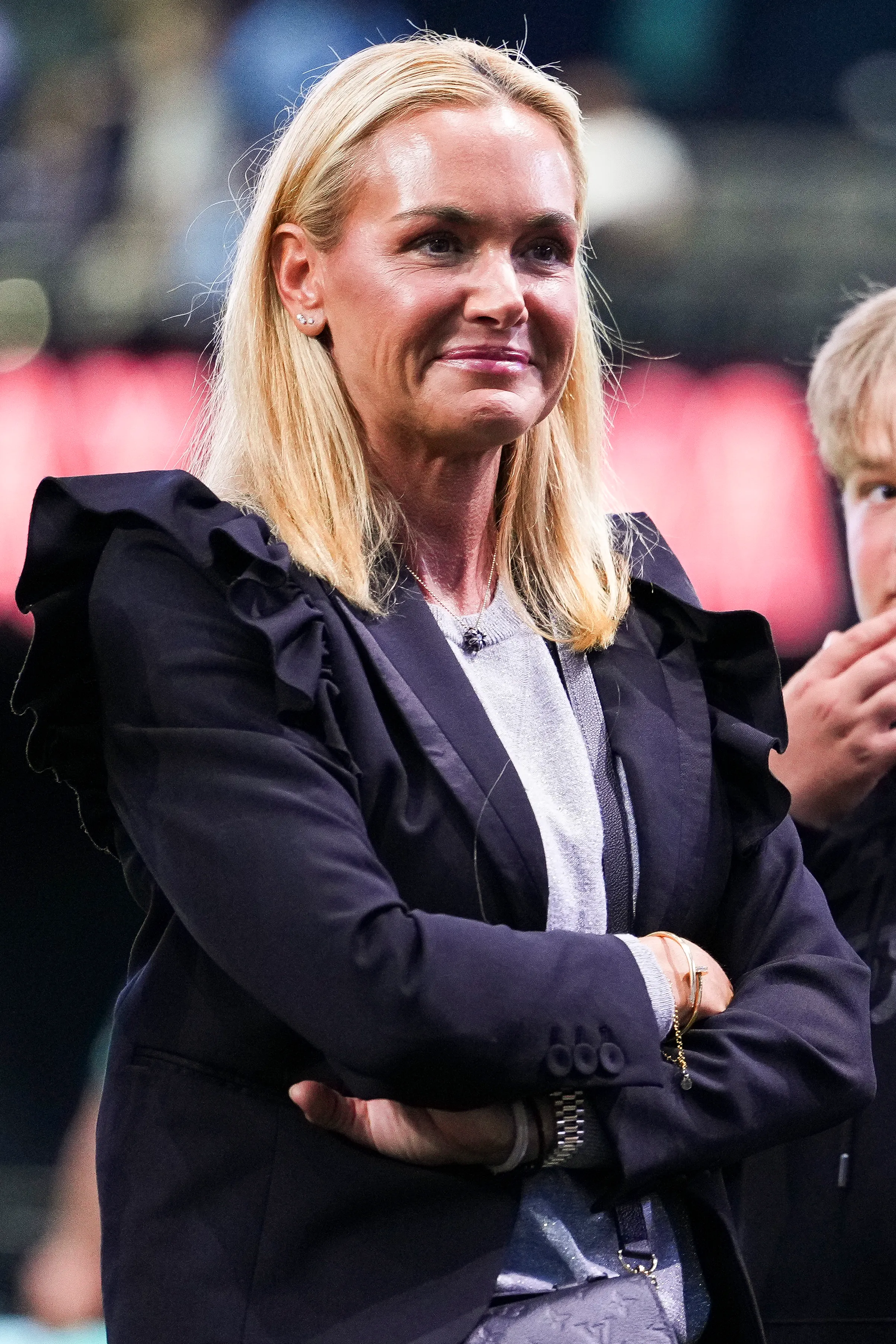 Vanessa Trump with arms crossed at a golf match.