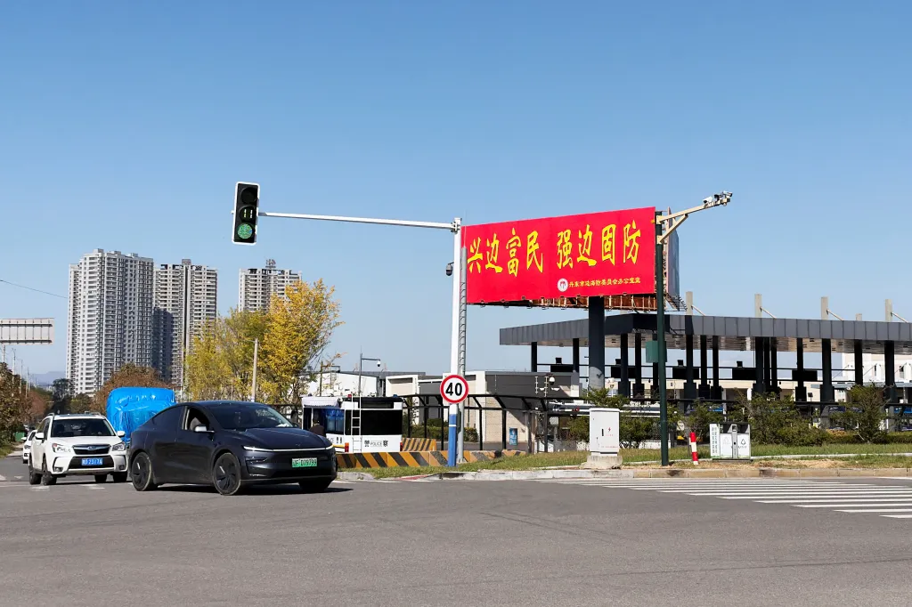 Vehicles travel past the Chinese customs facility for the New Yalu River Bridge in Dandong, Liaoning province, China, on Oct. 6, 2026.