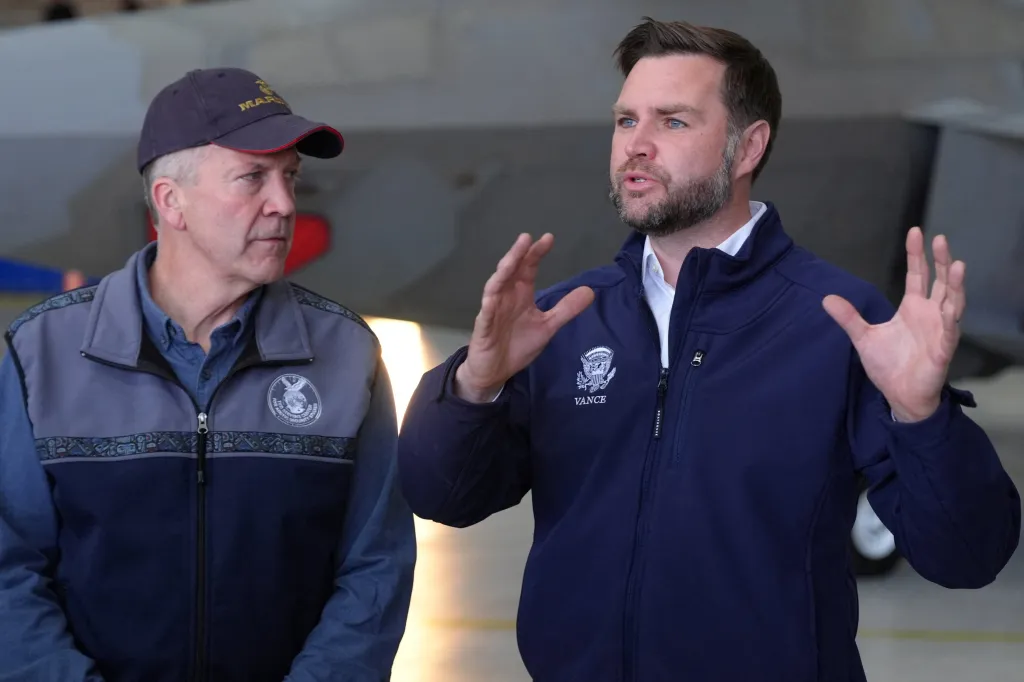 Vance speaks to reporters before boarding Air Force Two at Elmendorf Air Force Base in Anchorage, on Oct. 7, 2026, as Sen. Dan Sullivan, R-Alaska, listens.