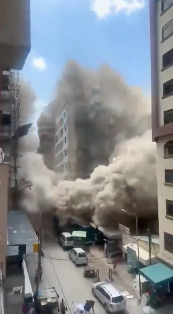An 18-story building under construction collapses, sending up a massive cloud of dust and debris over a street in Nairobi, Kenya.