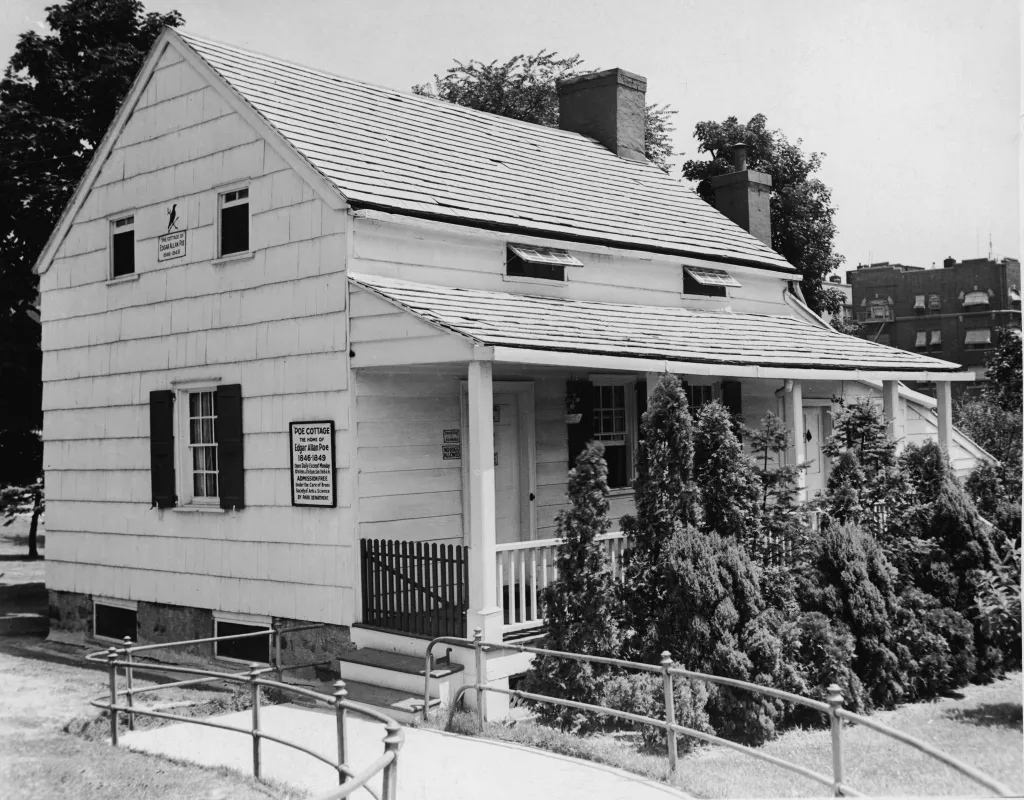 A black and white photo of the Edgar Allan Poe Cottage in the Bronx, New York.