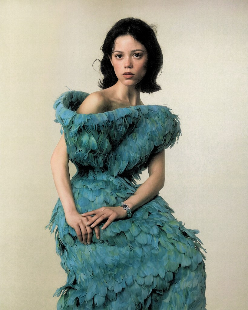 Jenna Ortega wearing a blue feathered dress.