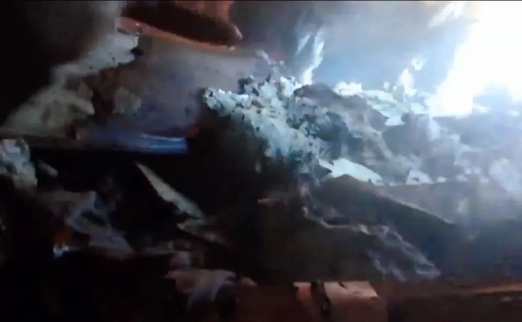 Body camera footage showing a search through smoldering debris at a fire in Edwards, Mississippi.