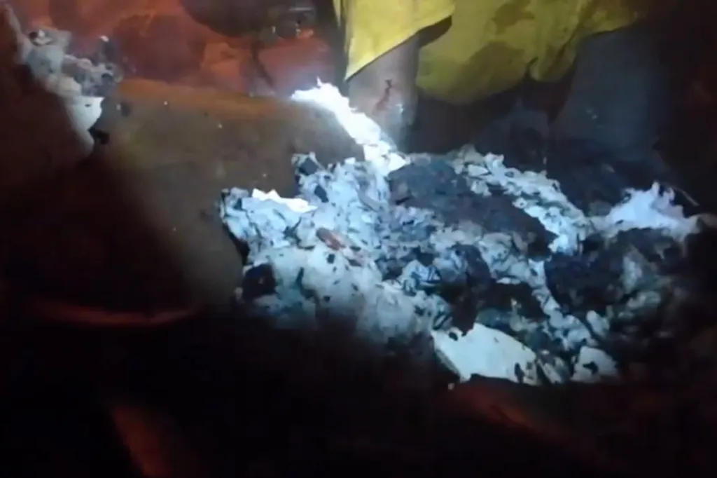 Deputies and neighbors search through smoldering debris to rescue a trapped child.