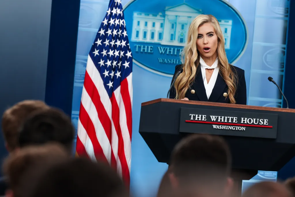 White House Press Secretary Katie Zacharia speaks at a podium in the James S. Brady Press Briefing Room.