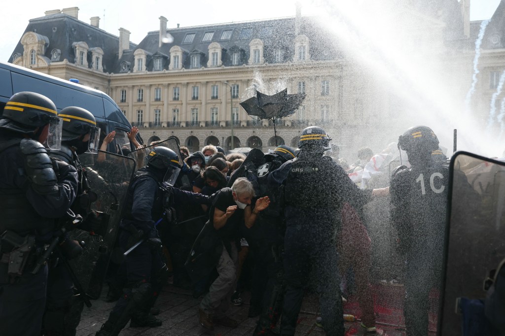 Riot police deploy a water cannon against protesters during demonstrations over learning conditions in Rennes, France.