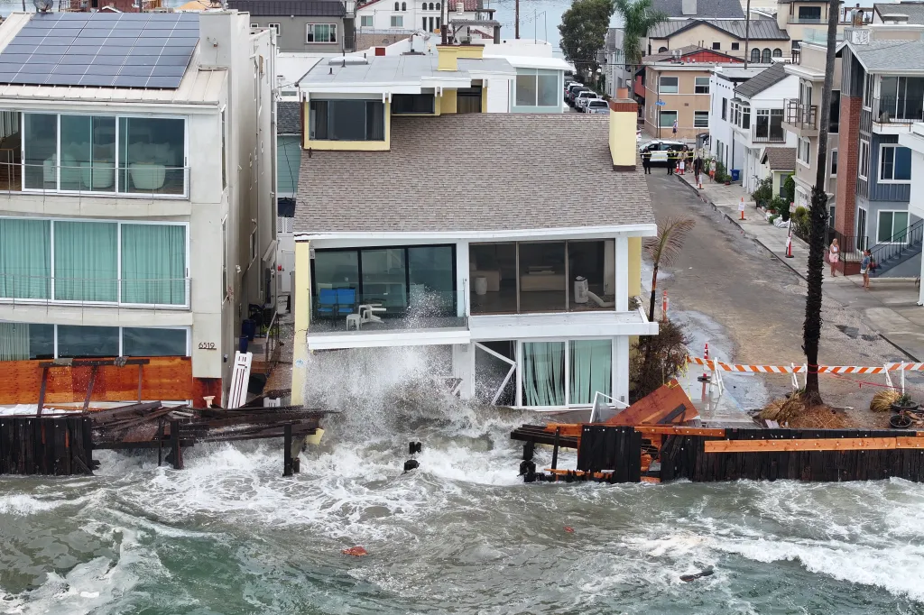 Waves crashing and damaging a home in Long Beach, Calif.