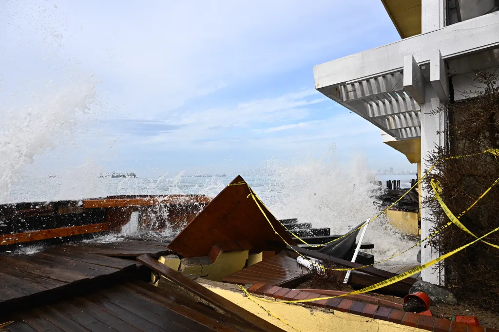 Waves damage a home in Long Beach, Calif.