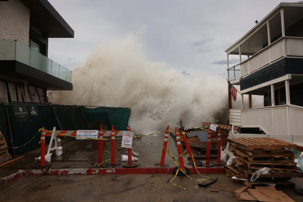 Waves generated by Tropical Storm Rachel crash over a boardwalk in Long Beach, California.