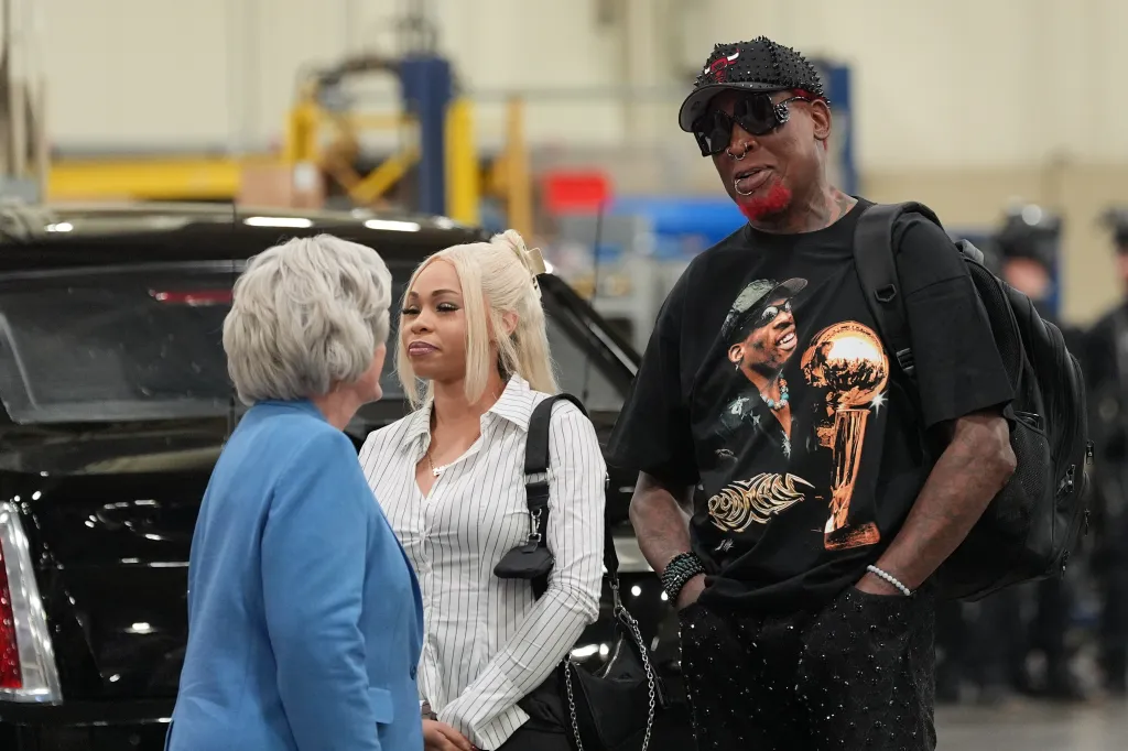 White House chief of staff Susie Wiles talks with Dennis Rodman.