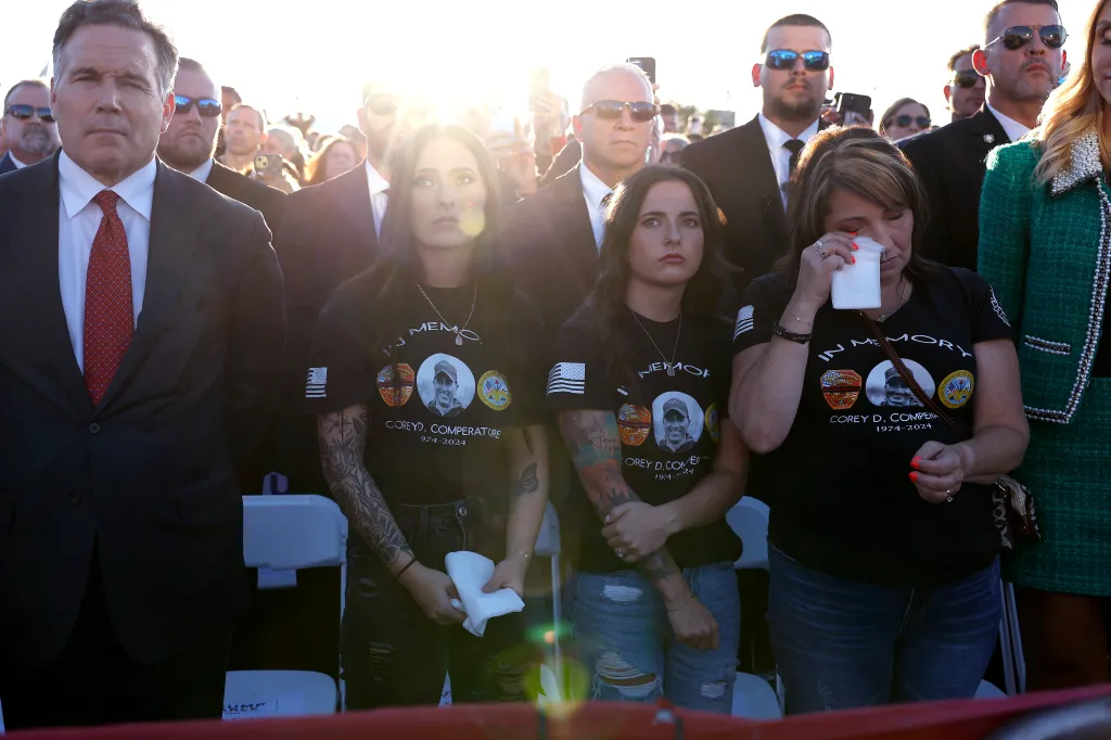 Helen Comperatore, the widow of firefighter Corey Comperatore, wipes away a tear as she and her daughters attend a political rally.