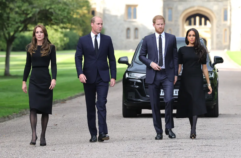Prince William, Catherine, Princess of Wales, Prince Harry, and Meghan Markle , all in black, walking together outside Windsor Castle.