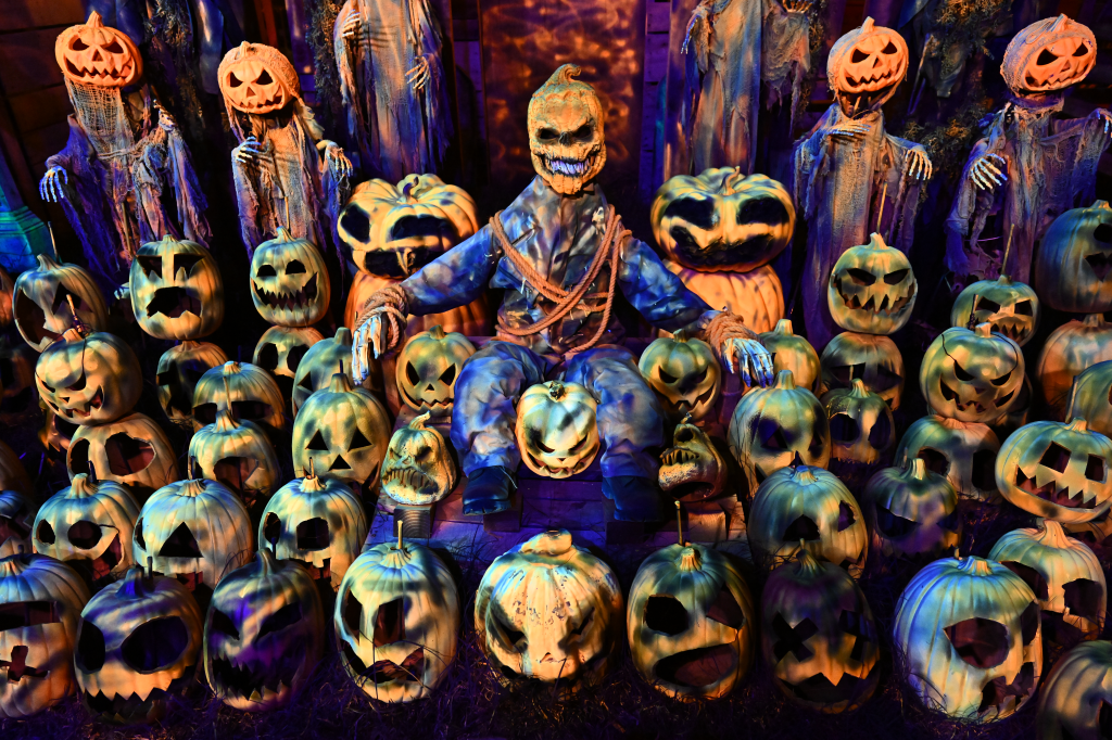A spooky Halloween display of carved pumpkins and ghostly figures arranged in a Burbank, Calif., yard.
