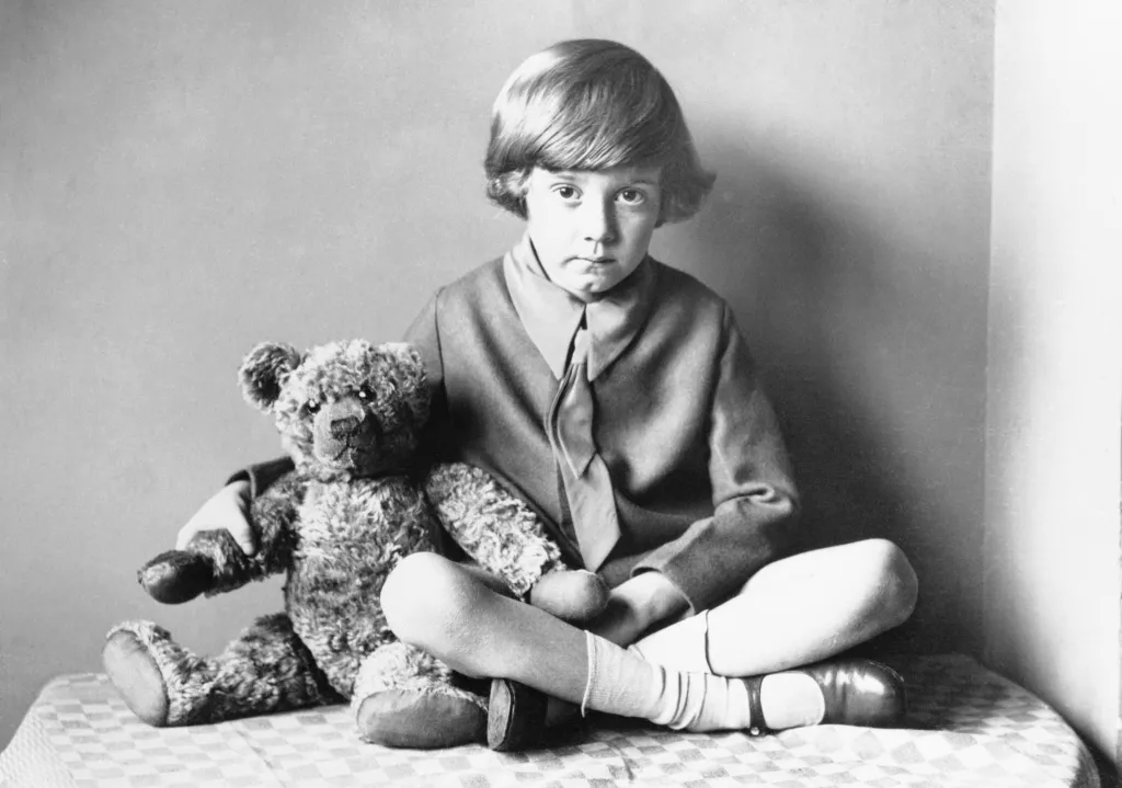 Christopher Robin Milne, son of Winnie the Pooh author A.A. Milne, sits at home with his teddy bear, circa 1925.