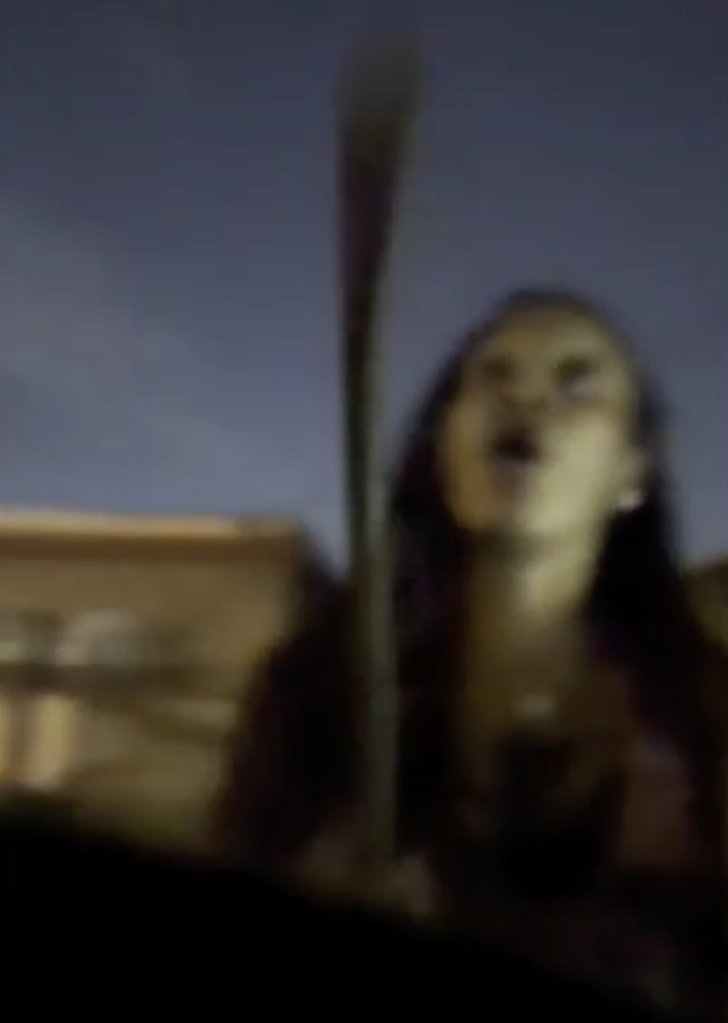 A blurry image of the woman holding a crowbar during the road rage attack.