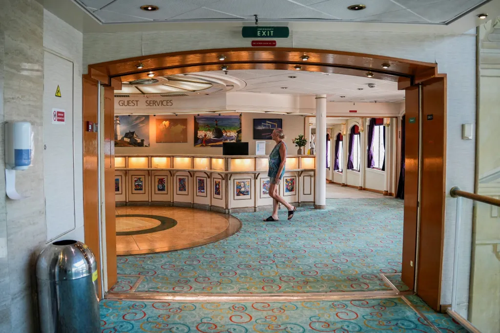 A former resident of the Villa Vie Odyssey walks inside the vessel to collect her belongings.