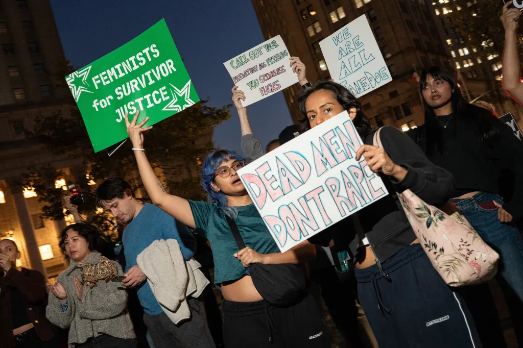 A woman holds a sign that reads