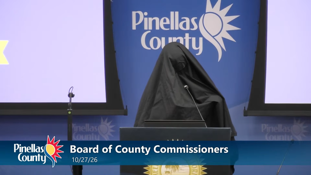 An unidentified woman, wearing a burka, stood at the podium of the Pinellas County Commissioners meeting and played a recording of an Islamic call to prayer on Oct. 27, 2026.