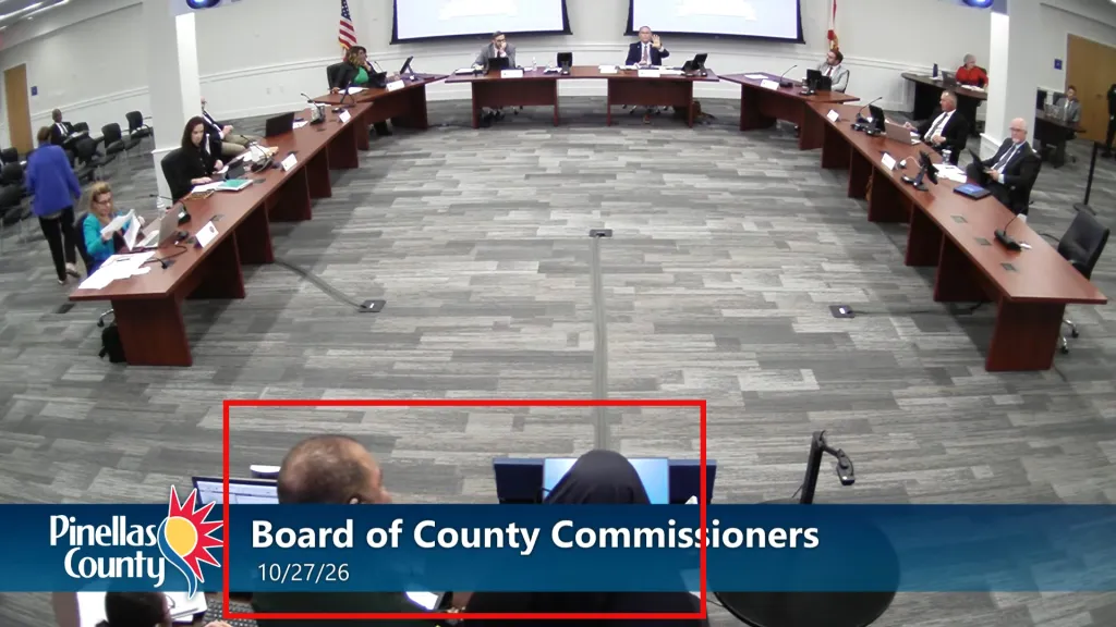 A Pinellas County Sheriff’s Office deputy approached the podium and escorted her out of the meeting room and the building after she refused to step down from the podium.