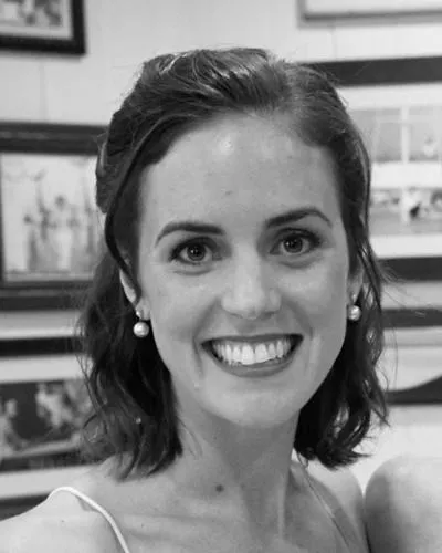 Black-and-white portrait of Kyle Kennedy smiling.