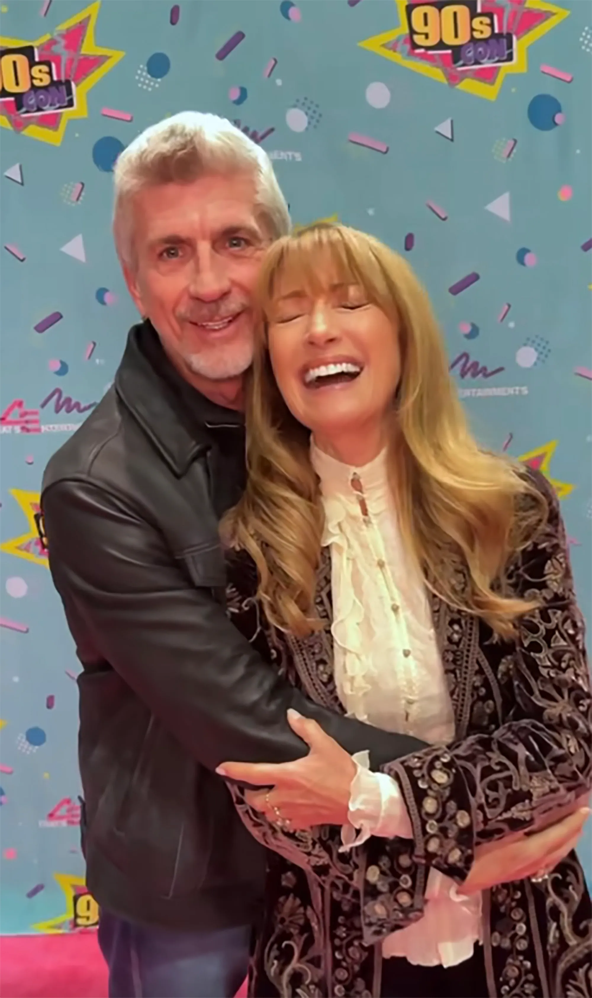 Jane Seymour and Joe Lando embrace and laugh in front of a 