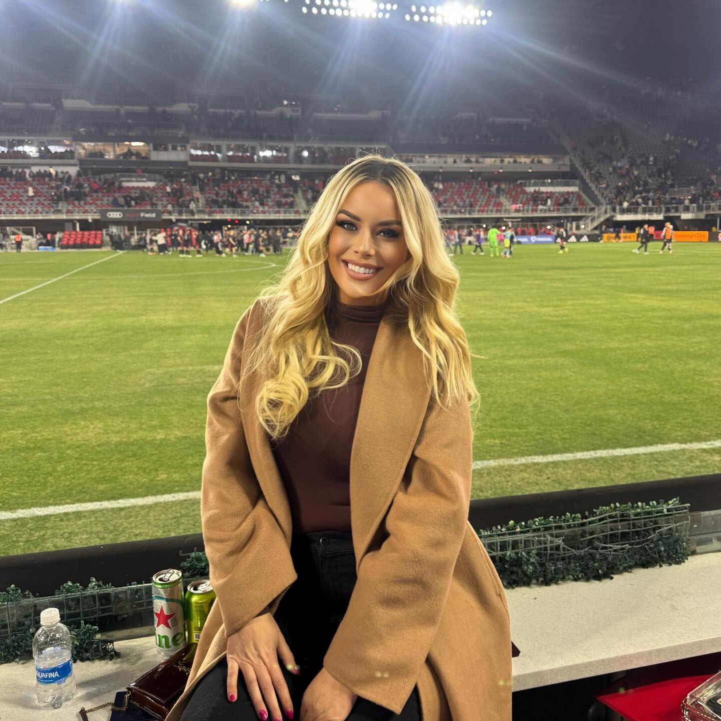 Britt McHenry sitting courtside at a sports game.