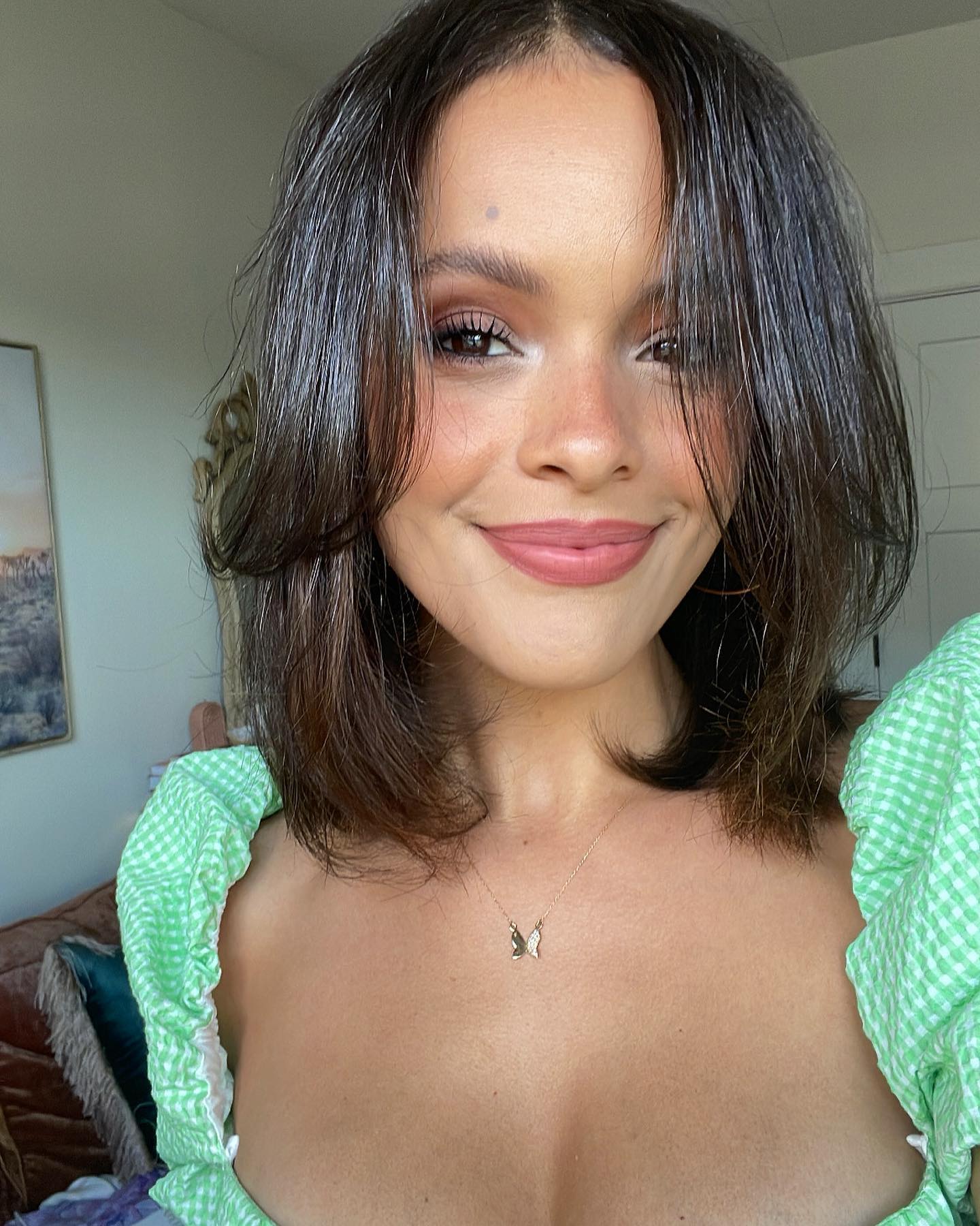 Portrait of Aubrey Cleland wearing a green gingham top.