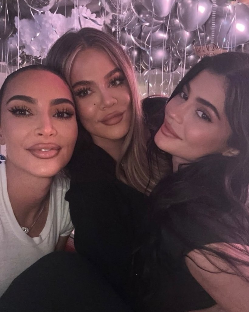 Kim Kardashian, Khloé Kardashian, and Kylie Jenner posing together.