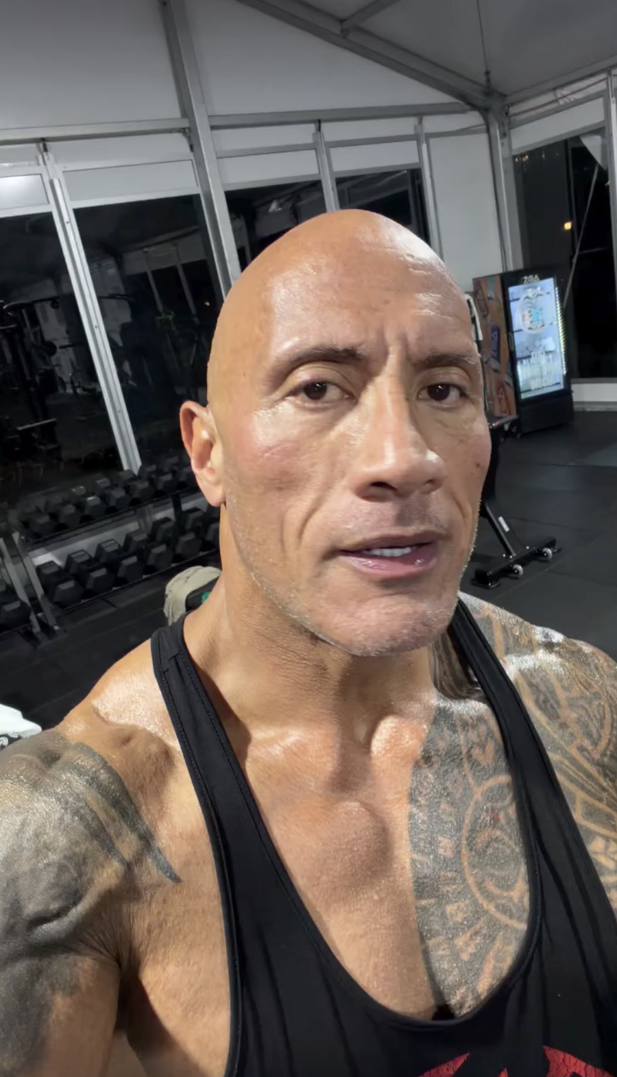 Dwayne Johnson works out in a gym.